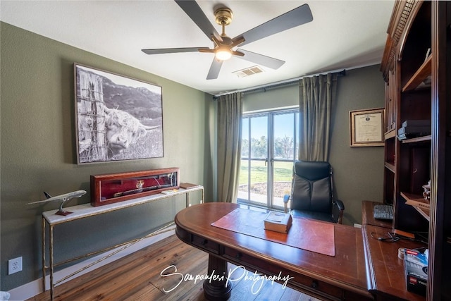 home office featuring visible vents, ceiling fan, and wood finished floors