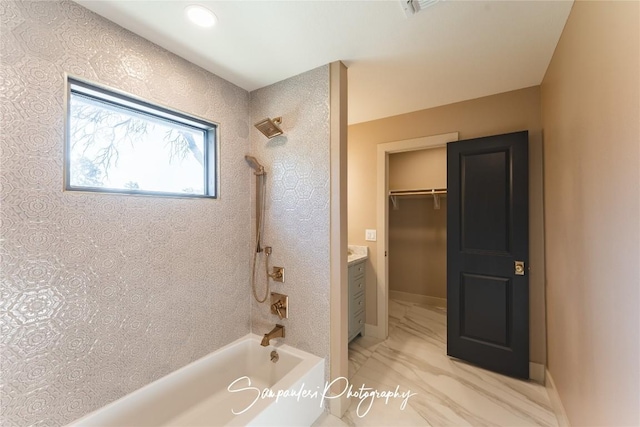 bathroom with baseboards, bathing tub / shower combination, marble finish floor, and vanity