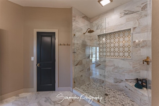 full bath with baseboards and a tile shower