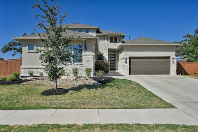 prairie-style home featuring stone siding, stucco siding, and fence