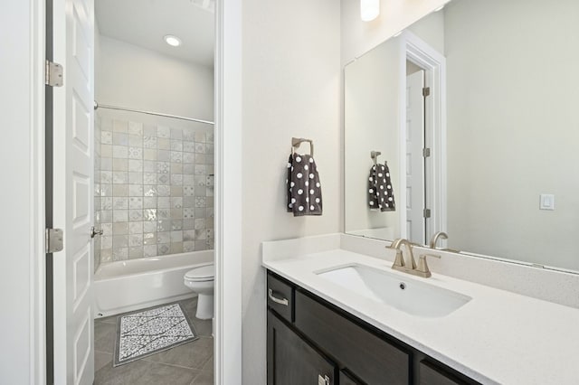 full bath featuring toilet, bathtub / shower combination, vanity, and tile patterned flooring