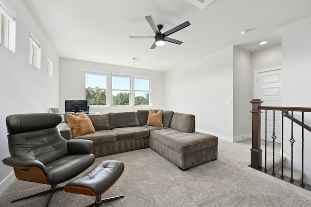 carpeted living area with visible vents and baseboards