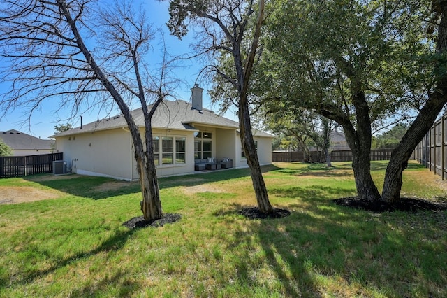 view of yard with central air condition unit and a fenced backyard