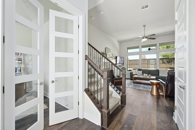 stairs featuring visible vents, french doors, a ceiling fan, and wood finished floors