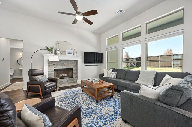 340 Axis Loop, Georgetown, TX 78628 - living room featuring wood finished floors, a ceiling fan, baseboards, and a fireplace