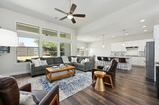 living room with visible vents, ceiling fan, baseboards, dark wood finished floors, and recessed lighting