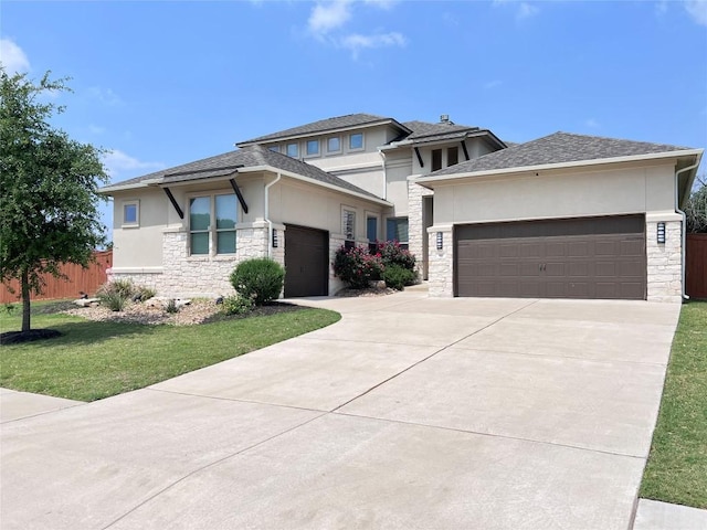 prairie-style home with stucco siding, driveway, an attached garage, and stone siding
