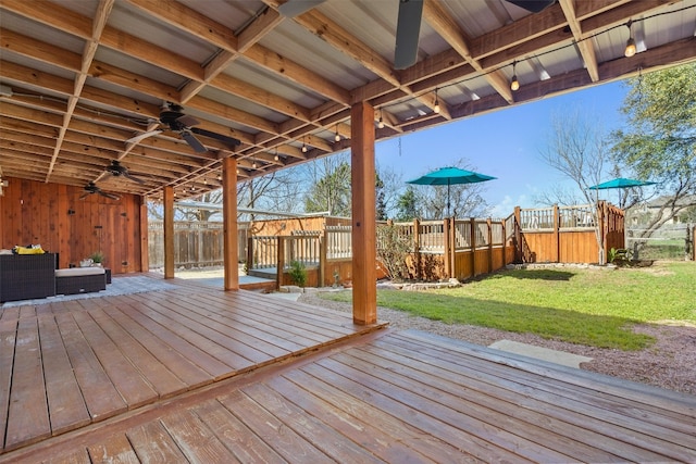 deck with a lawn, ceiling fan, and fence