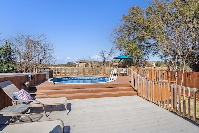 view of pool with a fenced in pool, a deck, and fence