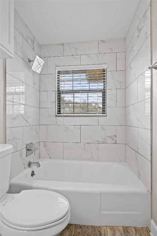 11705 Pollyanna Ave, Austin, TX 78753 - bathroom featuring shower / washtub combination and wood finished floors
