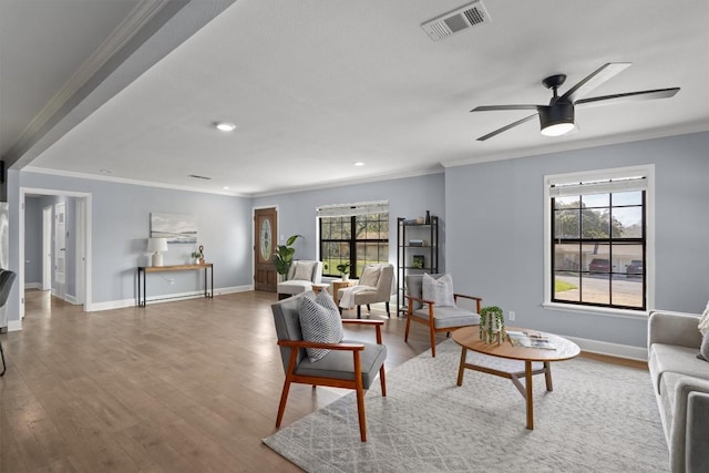 living room featuring wood finished floors, a ceiling fan, recessed lighting, crown molding, and baseboards