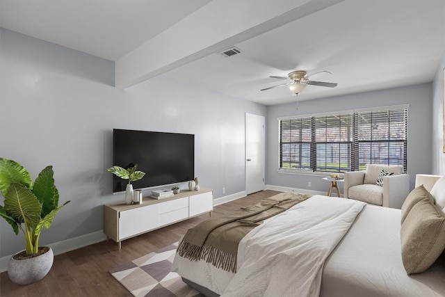 bedroom featuring ceiling fan, visible vents, baseboards, and wood finished floors