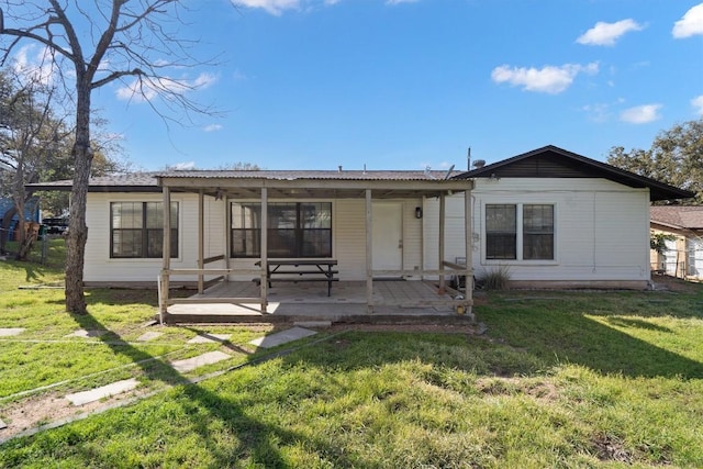 rear view of house featuring a patio and a yard