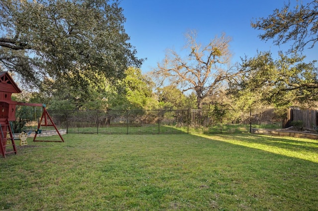 view of yard with a fenced backyard and a playground