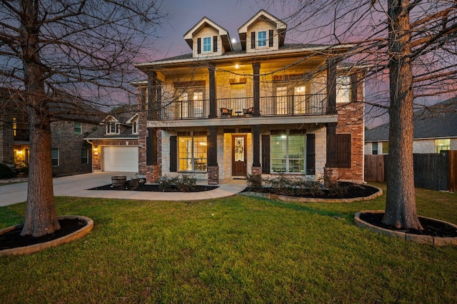 view of front of property featuring a balcony, a front lawn, and fence