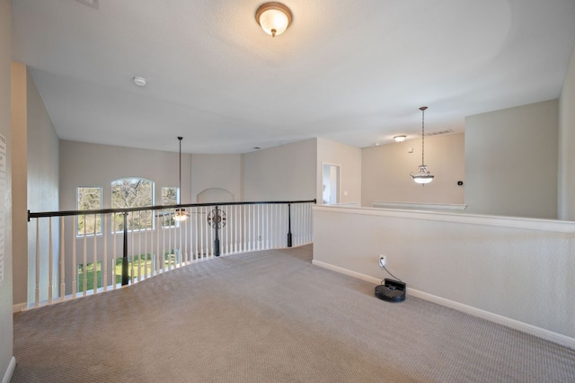 carpeted empty room with baseboards