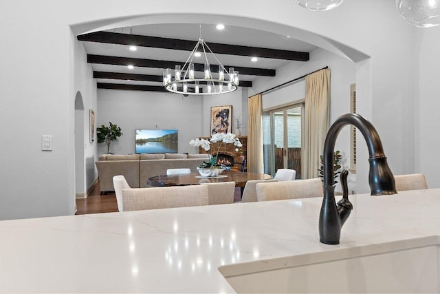12500 Verandah Ct, Austin, TX 78726 - dining room with arched walkways, beam ceiling, a chandelier, and wood finished floors