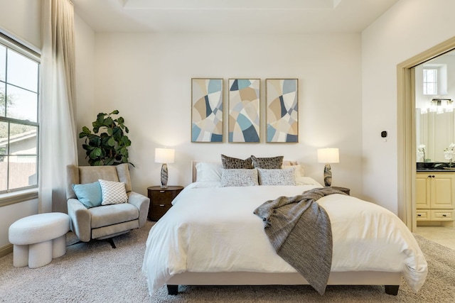 bedroom featuring carpet and ensuite bath