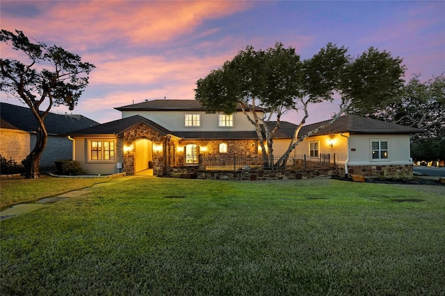 12500 Verandah Ct, Austin, TX 78726 - back of house at dusk with stone siding, stucco siding, and a yard