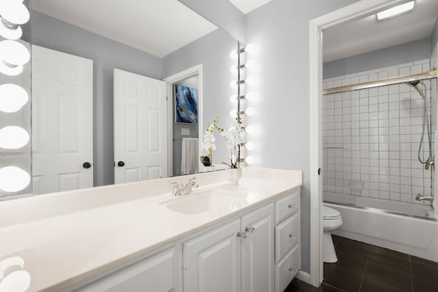 bathroom featuring toilet, shower / washtub combination, vanity, and tile patterned flooring