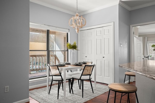 dining area featuring baseboards, an inviting chandelier, and crown molding