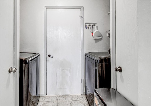 clothes washing area with laundry area and washer and clothes dryer