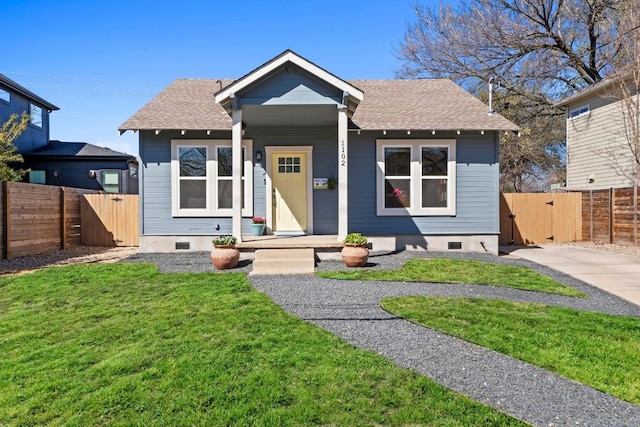 bungalow-style house with a shingled roof, a gate, fence, and crawl space