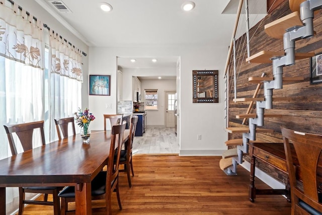 dining room with recessed lighting, visible vents, light wood-style floors, and stairway