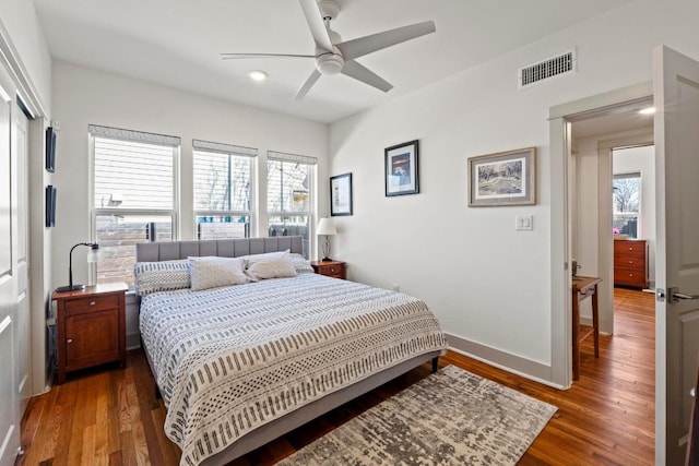 bedroom featuring multiple windows, wood finished floors, and visible vents