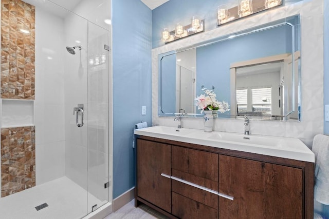 full bath featuring a sink, a stall shower, and double vanity