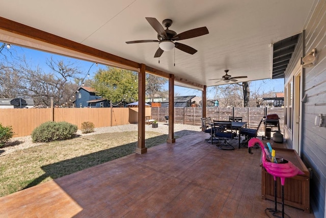 view of patio / terrace with outdoor dining area, a ceiling fan, and a fenced backyard