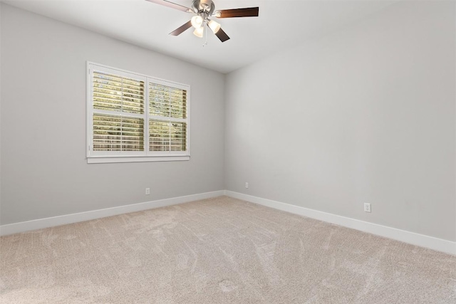 unfurnished room featuring light carpet, a ceiling fan, and baseboards