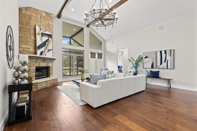 living area featuring high vaulted ceiling, a fireplace, dark wood-style flooring, beamed ceiling, and a chandelier