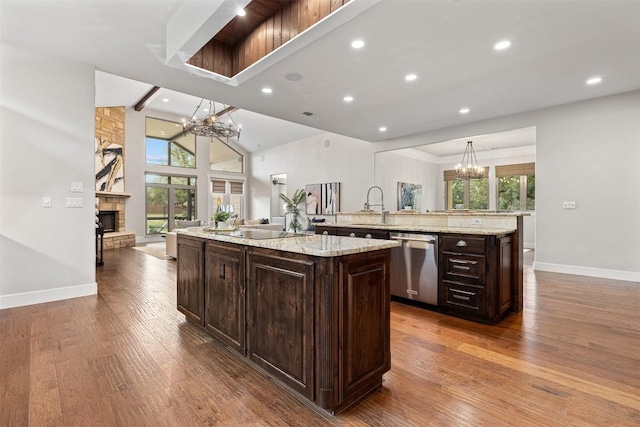 kitchen featuring plenty of natural light, a large island, dishwasher, a notable chandelier, and open floor plan