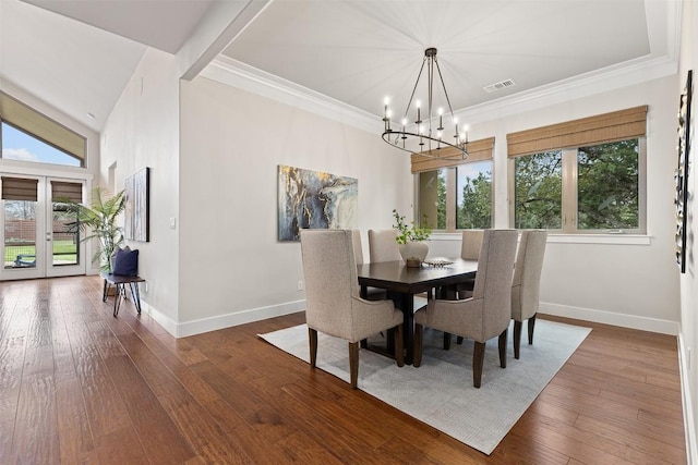 dining space featuring plenty of natural light, baseboards, a chandelier, wood-type flooring, and crown molding