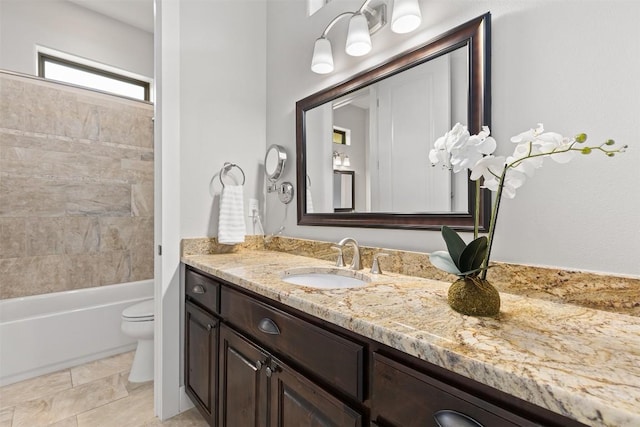 full bath featuring toilet, vanity, and bathing tub / shower combination