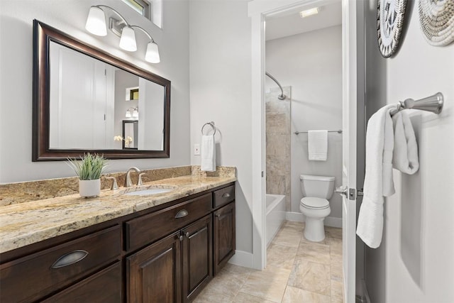 bathroom featuring toilet, vanity, baseboards, and washtub / shower combination