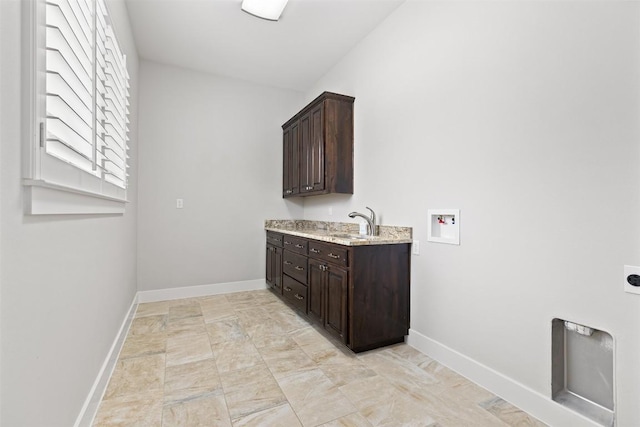 clothes washing area featuring electric dryer hookup, cabinet space, hookup for a washing machine, and baseboards