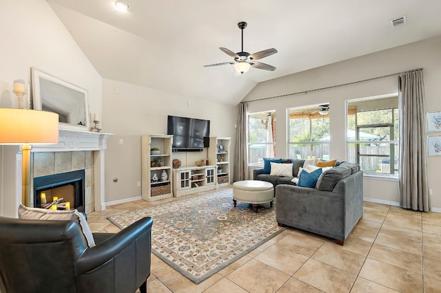 living room featuring light tile patterned floors, visible vents, lofted ceiling, and ceiling fan