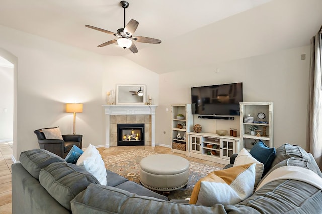 living room with light tile patterned flooring, a fireplace, lofted ceiling, and ceiling fan