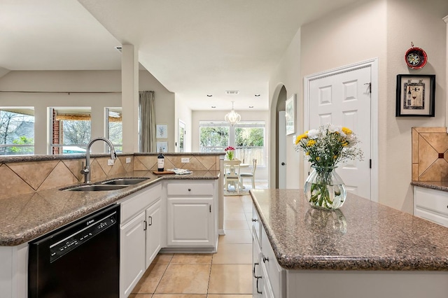 kitchen featuring dishwasher, an island with sink, white cabinetry, and a sink