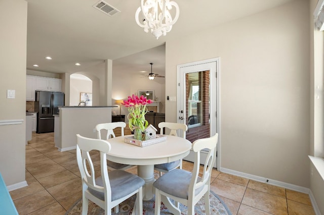 dining area with light tile patterned floors, visible vents, baseboards, recessed lighting, and ceiling fan with notable chandelier