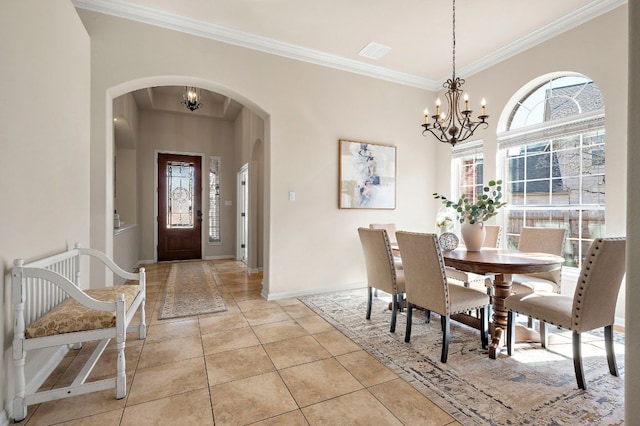 dining room with baseboards, a chandelier, ornamental molding, light tile patterned floors, and arched walkways