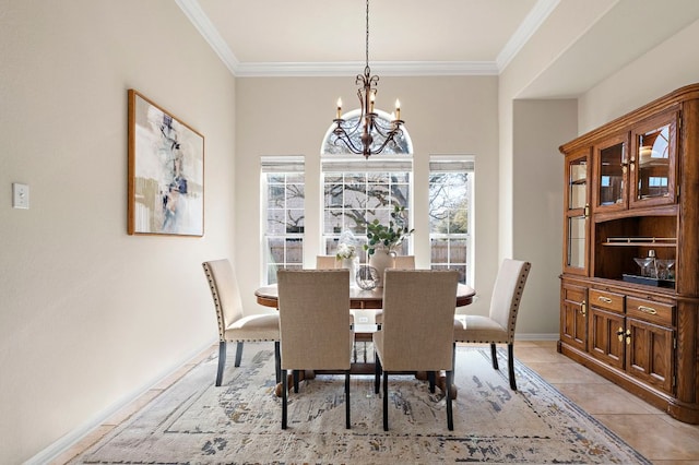 dining room with a wealth of natural light, a notable chandelier, light tile patterned floors, and ornamental molding