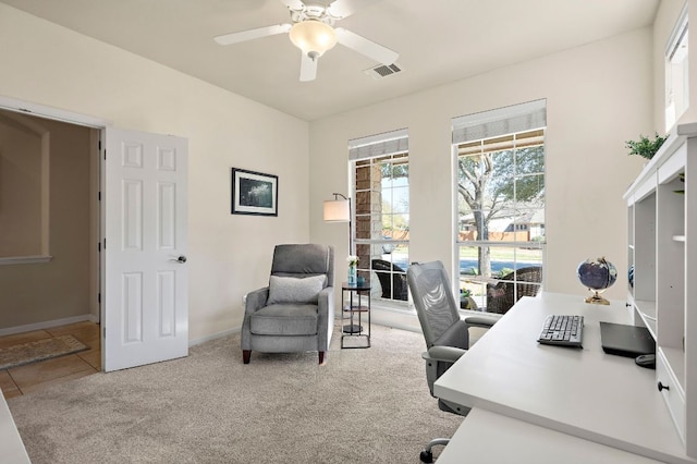 tiled office space featuring carpet flooring, ceiling fan, baseboards, and visible vents