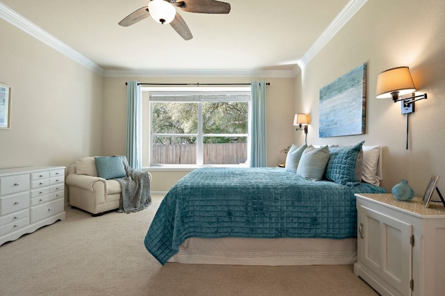 carpeted bedroom featuring ceiling fan and crown molding