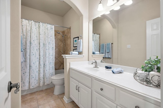 bathroom with tile patterned floors, toilet, vanity, and shower / bathtub combination with curtain