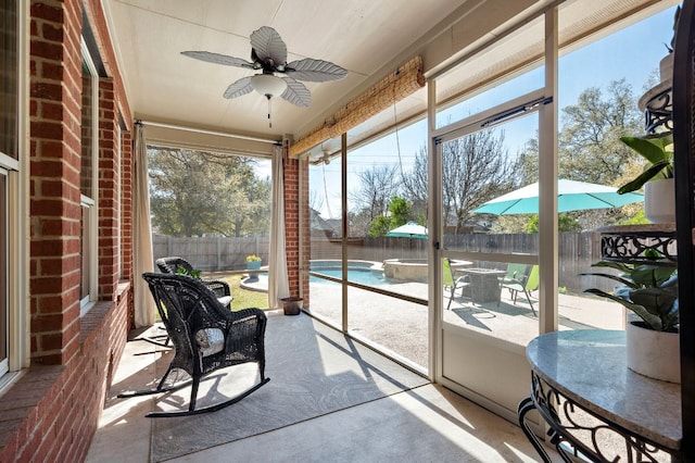 sunroom / solarium featuring ceiling fan