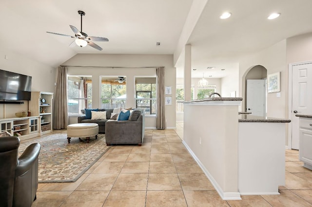 living room featuring recessed lighting, light tile patterned floors, baseboards, ceiling fan, and vaulted ceiling