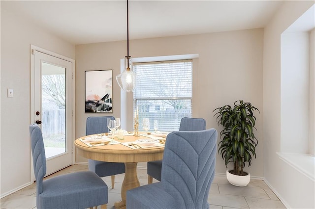 dining area with light tile patterned floors and baseboards